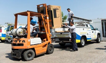 Carefully loading brand new equipment from our yard